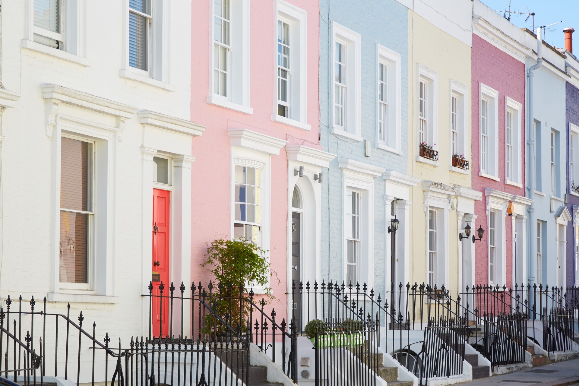 Colorful English houses facades, pastel pale colors in London